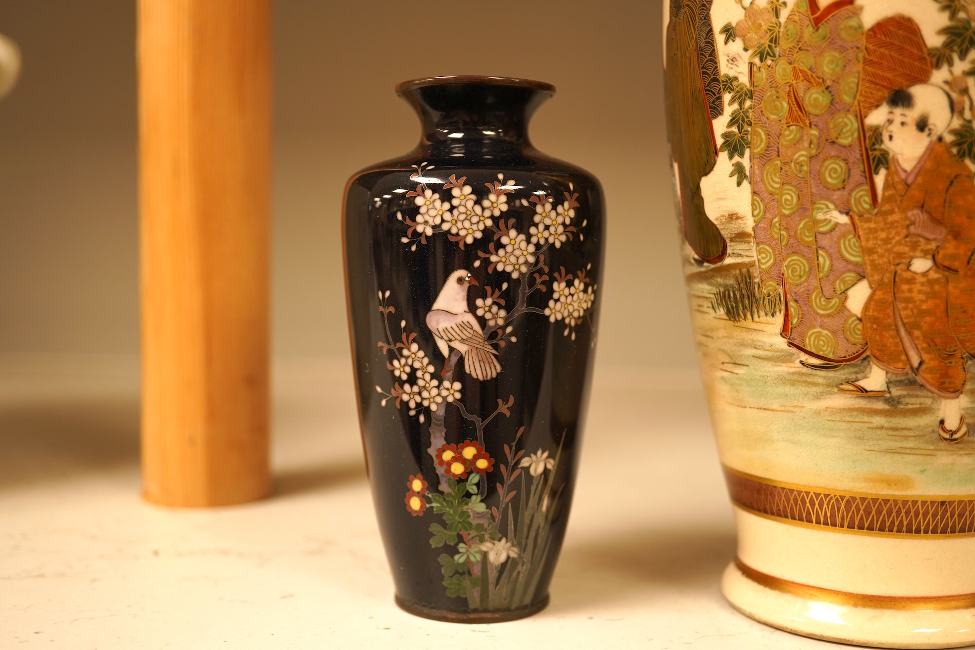 A Japanese figural satsuma vase and a pair of small black cloisonné enamel vases, Satsuma 21.5cm high